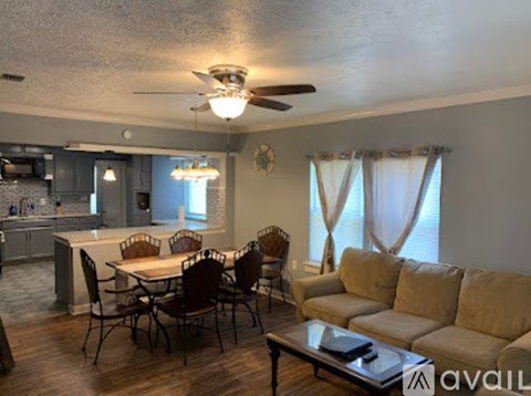A living room with a dining table and chairs.