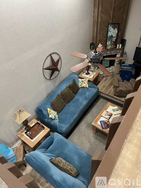 A living room with a blue couch and a wooden coffee table.