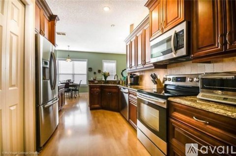 A kitchen with wooden cabinets and stainless steel appliances.