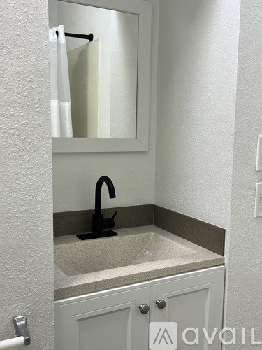 A bathroom with a sink and a mirror.