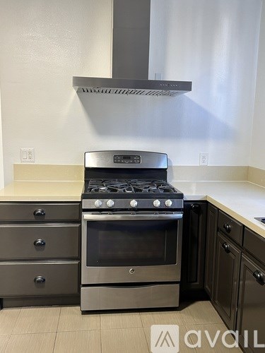 A modern kitchen with a stainless steel oven and range.