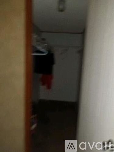 A small, dark room with a door on the left.