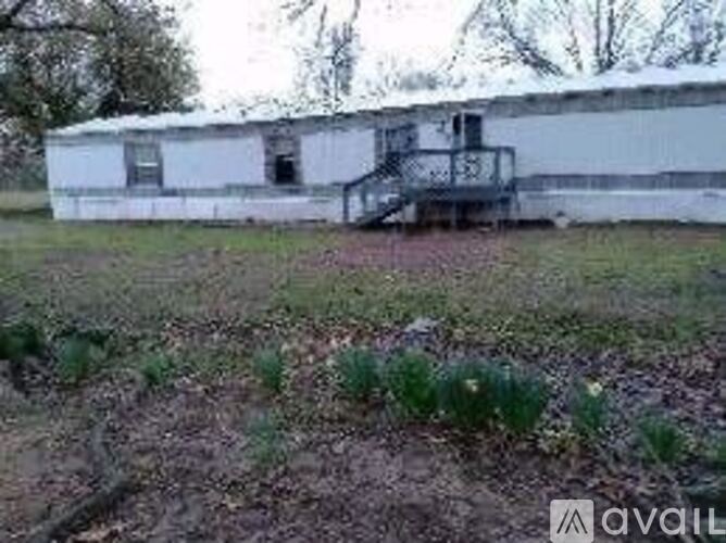 A white building with a black staircase in front of it.