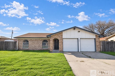 A house with a garage is for sale.
