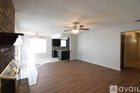 A living room with a television and a ceiling fan.
