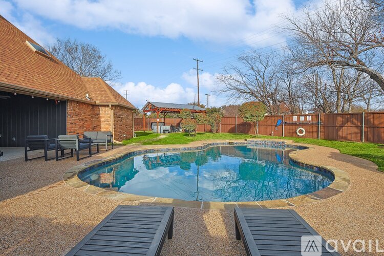A backyard with a pool and a deck.