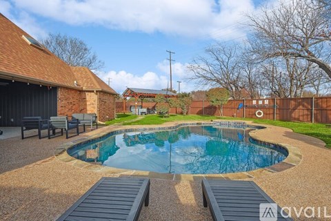A backyard with a pool and a deck.