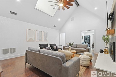 A living room with a grey couch and a white coffee table.