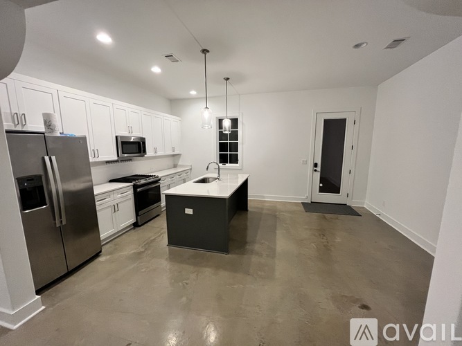 A kitchen with white cabinets and stainless steel appliances.