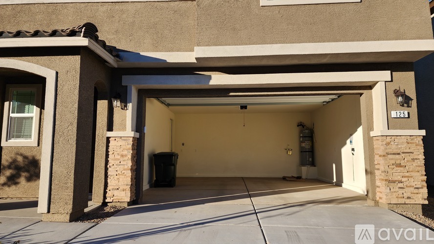 A house with a brown garage door and a white driveway.
