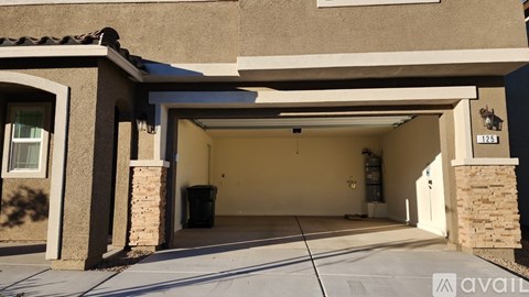 A house with a brown garage door and a white driveway.