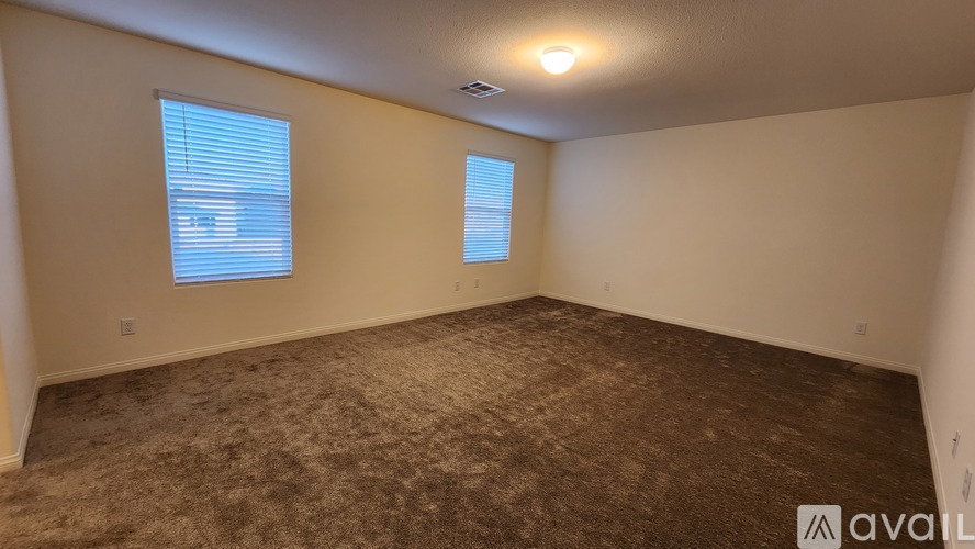 A bathroom with a toilet and a carpeted floor.