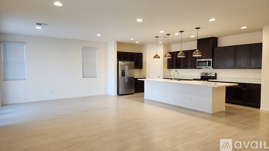A garage door is open to a clean, empty garage.
