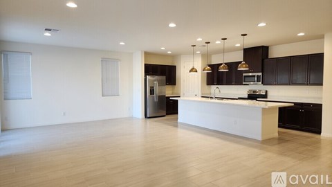 A garage door is open to a clean, empty garage.