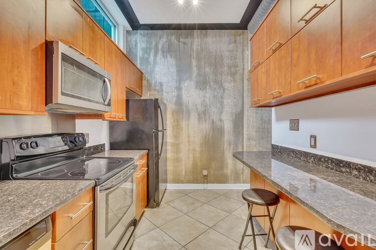A kitchen with a stove, oven, microwave, and refrigerator.