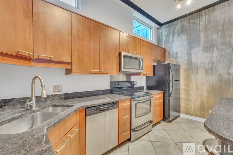 A kitchen with wooden cabinets and stainless steel appliances.