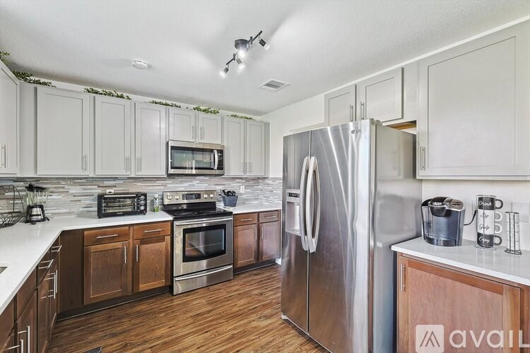 A kitchen with wooden cabinets and stainless steel appliances.