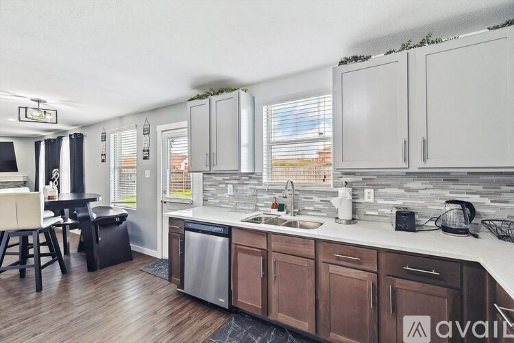 A kitchen with wooden cabinets and a white countertop.