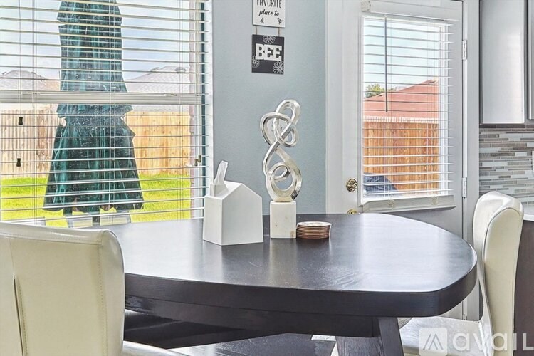 A dining table with a white chair and a decorative item on it.