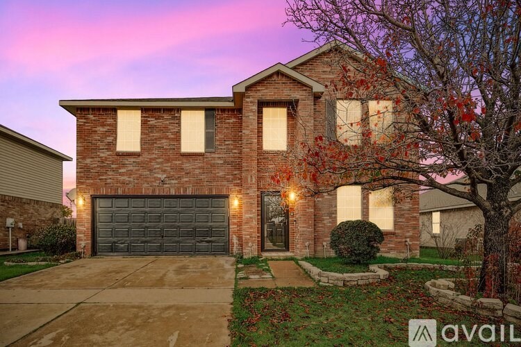 A house with a brick facade and a large front yard.