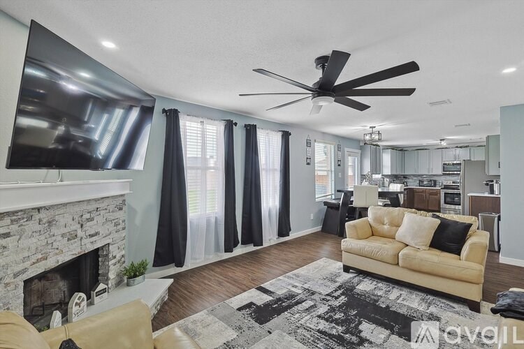 A living room with a fireplace and a television.