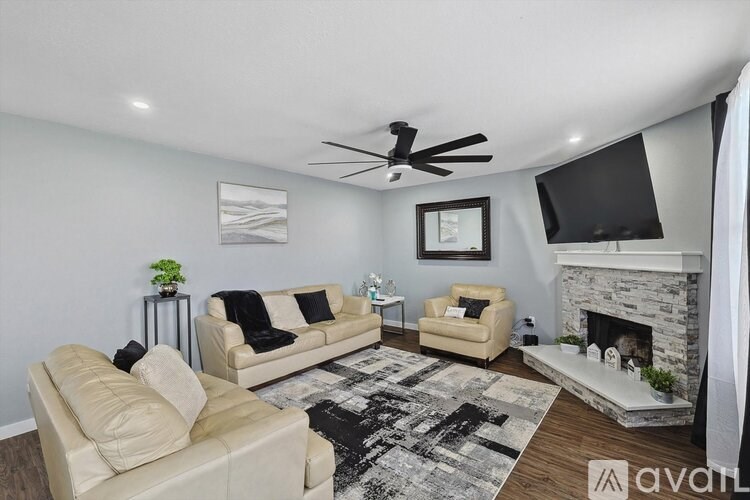 A living room with a fireplace and a television.
