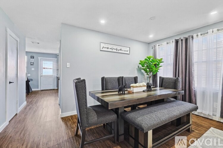 A dining room with a wooden table and chairs.