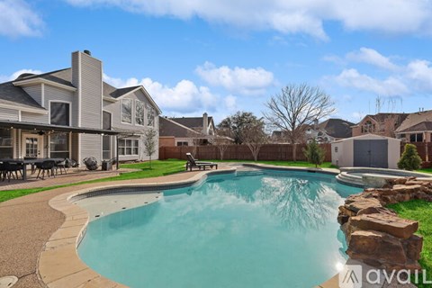 A large swimming pool in a backyard with a house in the background.