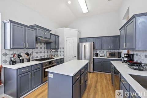 A kitchen with dark blue cabinets and a white countertop.
