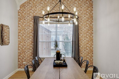 A dining room with a wooden table and chairs.