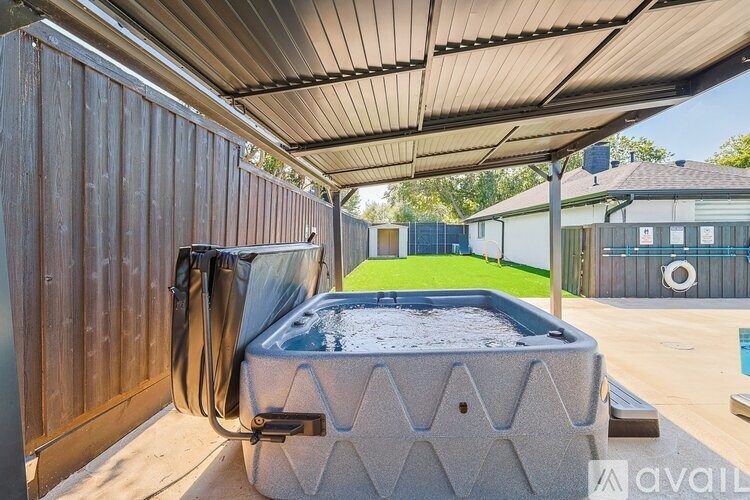 A bedroom with a large bed and a round orange wall.