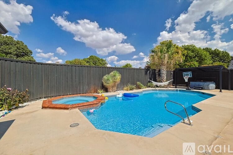 A pool with a blue water and a brown mat on the floor.