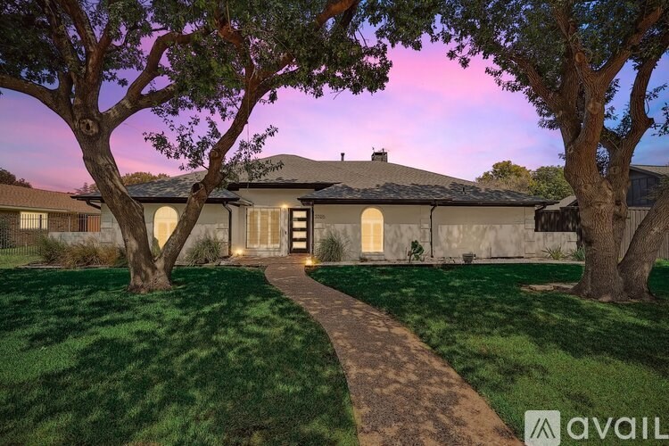 A house with a pathway leading to the front door.