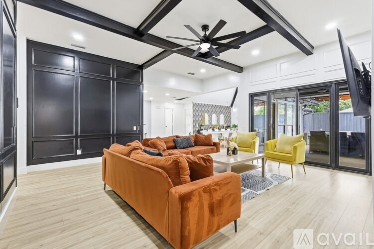 A modern dining room with a long table and chairs.