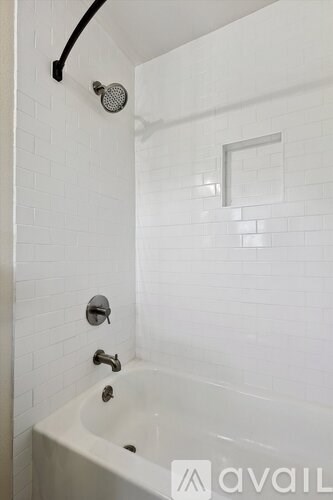 A white bathroom with a tub and shower.