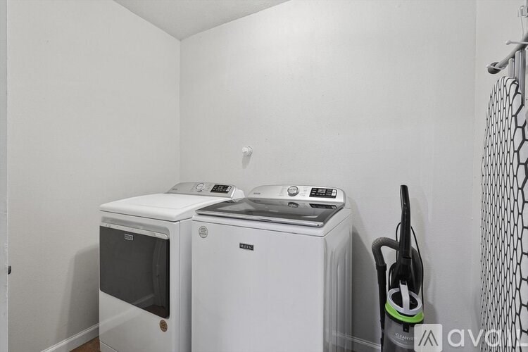 A white microwave oven is on top of a white dishwasher.