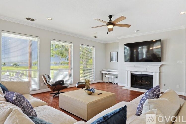 A living room with a fireplace and a television.