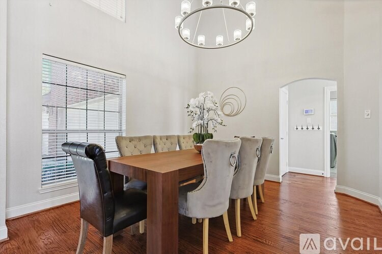 A dining room with a wooden table and chairs.