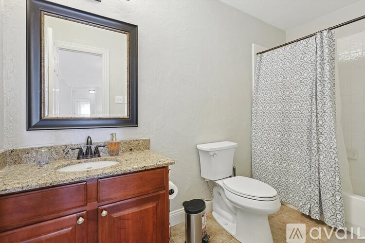 A bathroom with a sink, toilet, and shower.