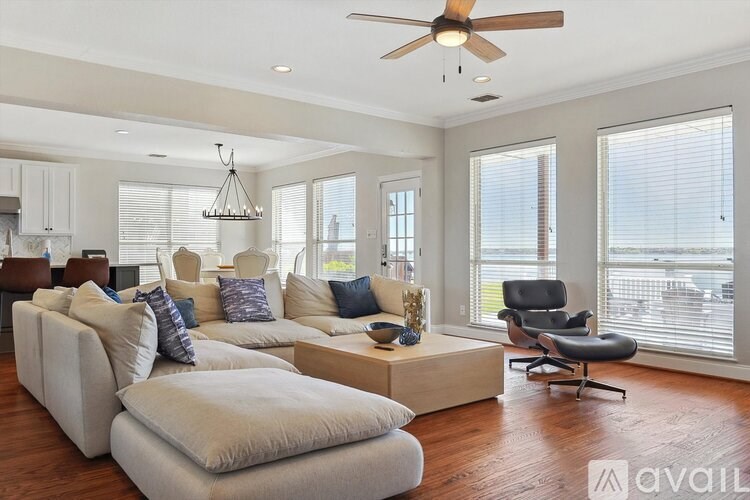 A living room with a white couch and a ceiling fan.