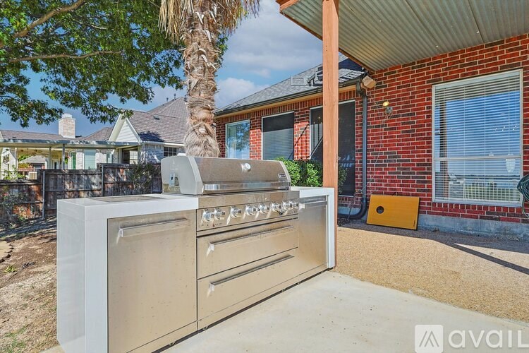 A large outdoor kitchen with a grill and sink is available for rent.