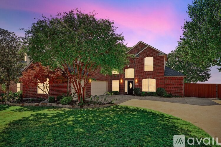 A house with a red brick exterior and a large front yard.