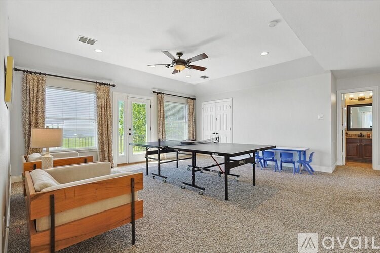 A living room with a dining table and chairs.