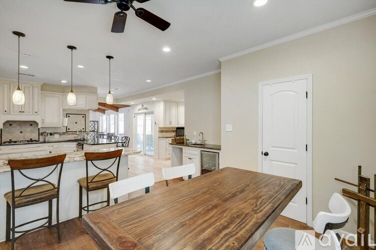 A kitchen with a wooden table and chairs.