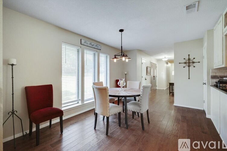 A dining room with a table set for four.