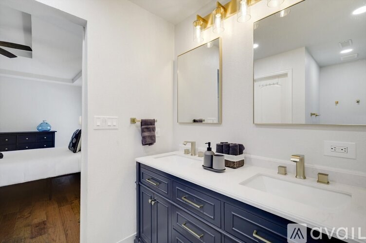 A bathroom with a white counter and a mirror above it.