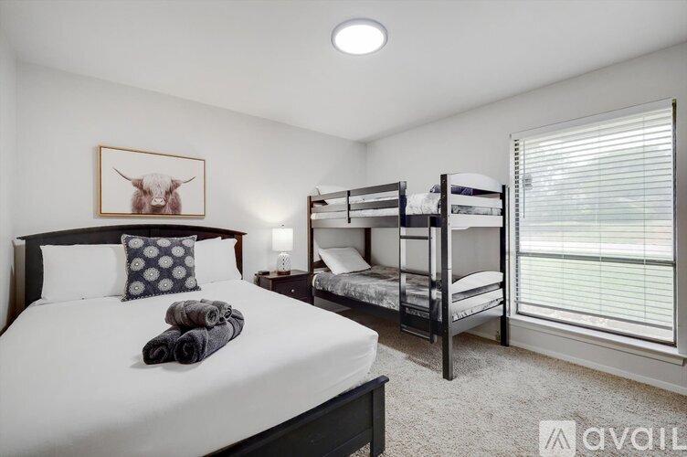 A bedroom with a large bed and a bunk bed.