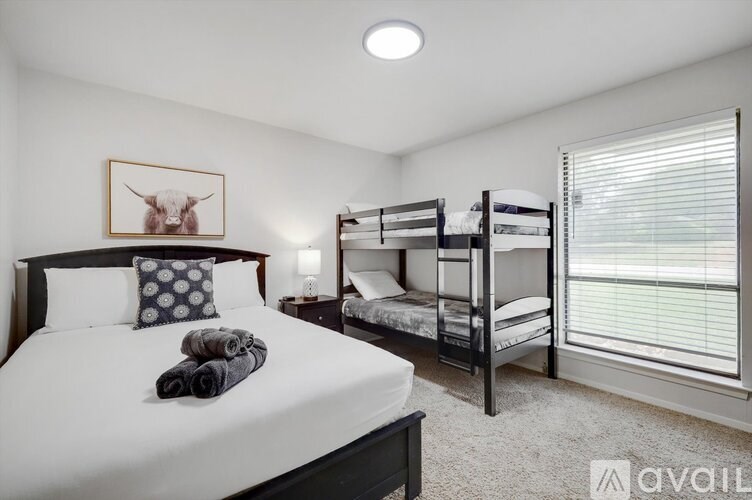 A bedroom with a large bed and a bunk bed.