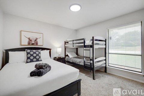 A bedroom with a large bed and a bunk bed.