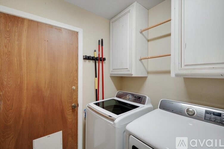 A small laundry room with a washer and dryer.